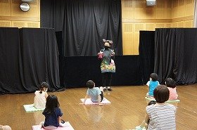 画像：ケロちゃんが演じるエプロンシアターに、お客さんが見入っている写真。