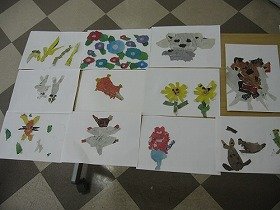 画像：完成したお花や子犬などの新聞ちぎり絵。