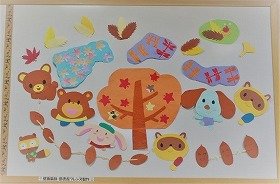 画像：色とりどりの葉っぱで遊ぶ動物たちとどんぐりの壁面装飾です。