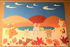 画用紙と折り紙で作った壁面飾りの画像。動物たちがリュックを背負って出かけるところです。