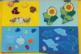 色画用紙で海の生き物やセミ、ひまわりなどが表現された夏の壁面飾りの画像