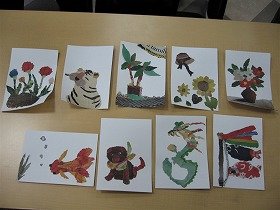 写真　参加者が作った新聞ちぎり絵。鯉のぼり、ひまわりと麦わら帽子、花瓶に入った椿、虎、辰などの作品。
