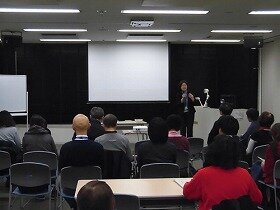 上映前の会場の様子。司会者の挨拶に耳を傾ける参加者の方々。