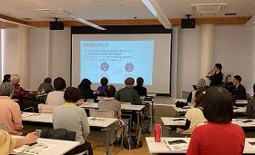 写真2：健康医療情報講座「The Radiology　画像診断　病気を見つけて治すまで」で講師の説明を聴いている参加者の様子。